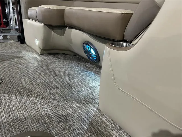 Slide: The Image of 2024 Veranda VR22RFL boat interior with cushioned seating and illuminated speaker. - 14
