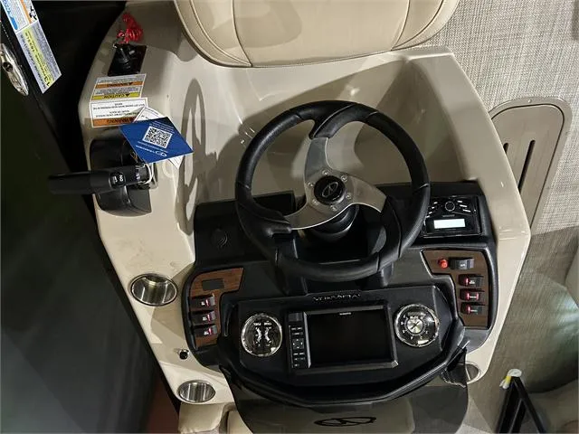 Slide: The Image of 2024 Veranda VR22RFL boat dashboard with steering wheel and control panel. - 19