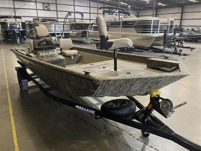 Slide: The Image of 2023 SeaArk RX 180 SC with Yamaha 90 SHO, camo design, displayed in a showroom. - 11