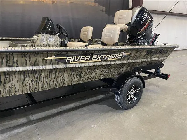 Slide: The Image of 2023 SeaArk RX 180 SC with Yamaha 90 SHO, camo design, in a showroom. - 9