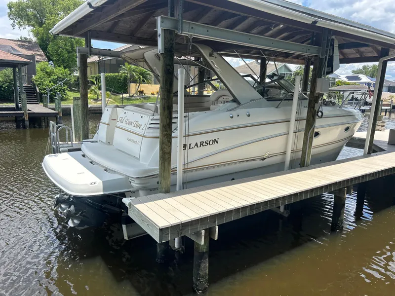 Slide: The Image of 2004 Larson 330 boat docked under a covered slip. - 1