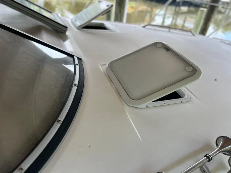 Slide: The Image of Close-up of 2004 Larson 330 boat deck with open hatch. - 14