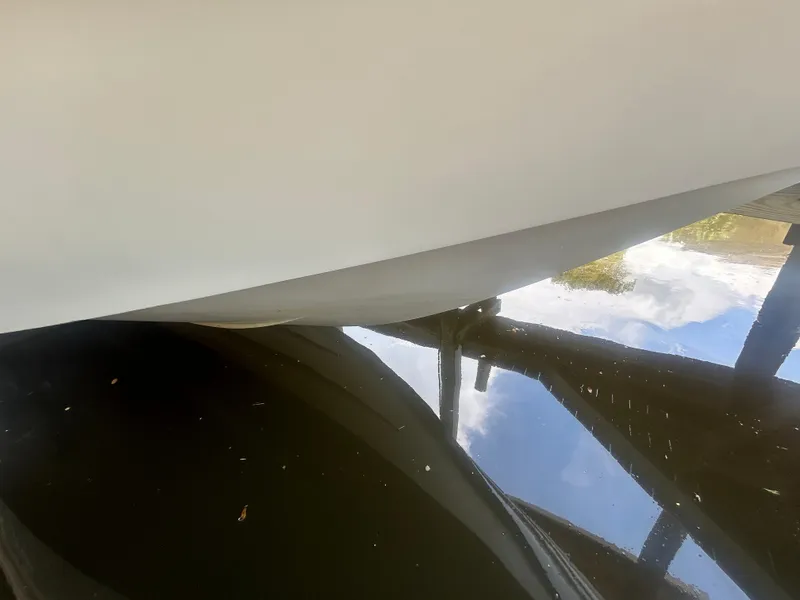 Slide: The Image of Close-up of 2004 Larson 330 boat hull reflecting on water. - 18