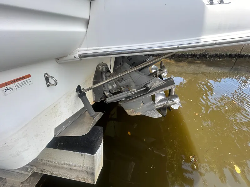 Slide: The Image of Larson 330 2004 boat stern drive and propellers in water. - 20