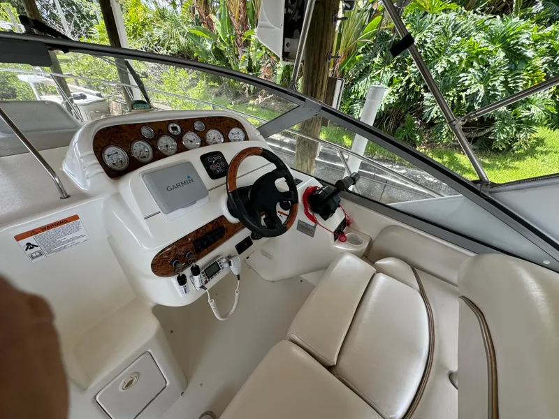 Slide: The Image of 2004 Larson 330 boat helm with Garmin navigation system and white leather seats. - 31