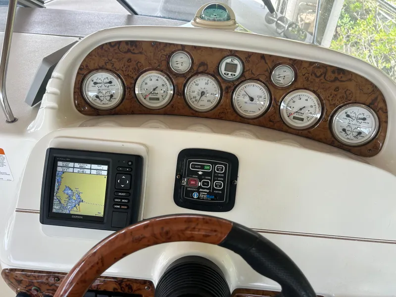 Slide: The Image of Dashboard of a 2004 Larson 330 boat with gauges and navigation system. - 32