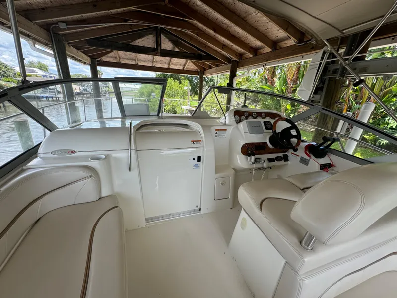Slide: The Image of 2004 Larson 330 boat interior with white seating and control panel. - 36