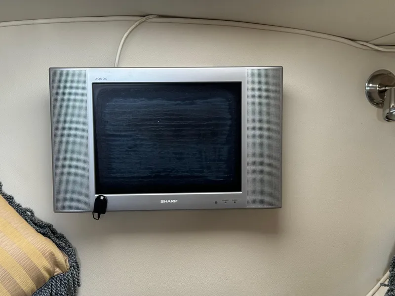 Slide: The Image of Wall-mounted Sharp TV in a 2004 Larson 330 boat cabin. - 41
