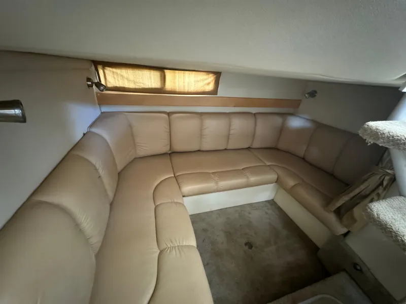 Slide: The Image of 2004 Larson 330 boat interior with beige leather seating. - 42