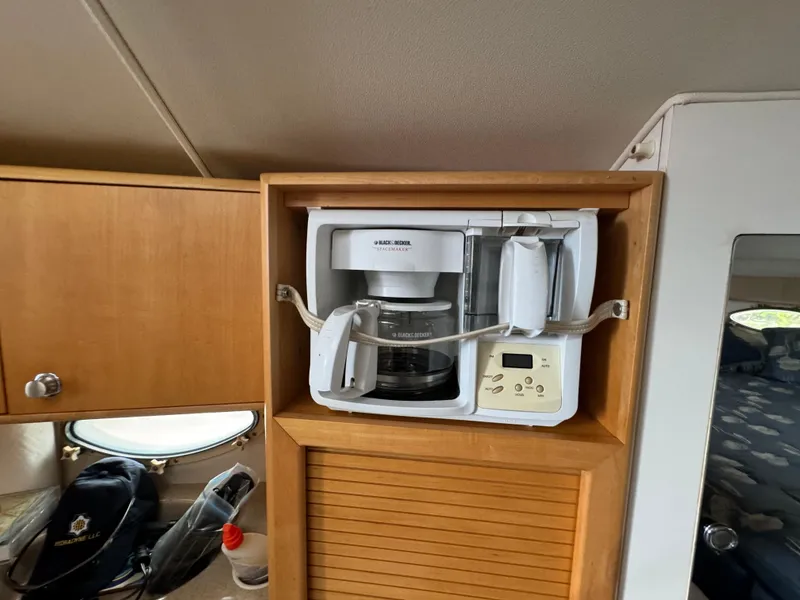 Slide: The Image of Built-in coffee maker in the kitchen of a 2004 Larson 330 boat. - 45