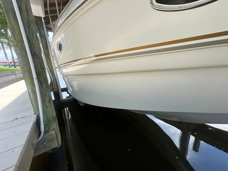 Slide: The Image of 2004 Larson 330 boat docked in a marina. - 5
