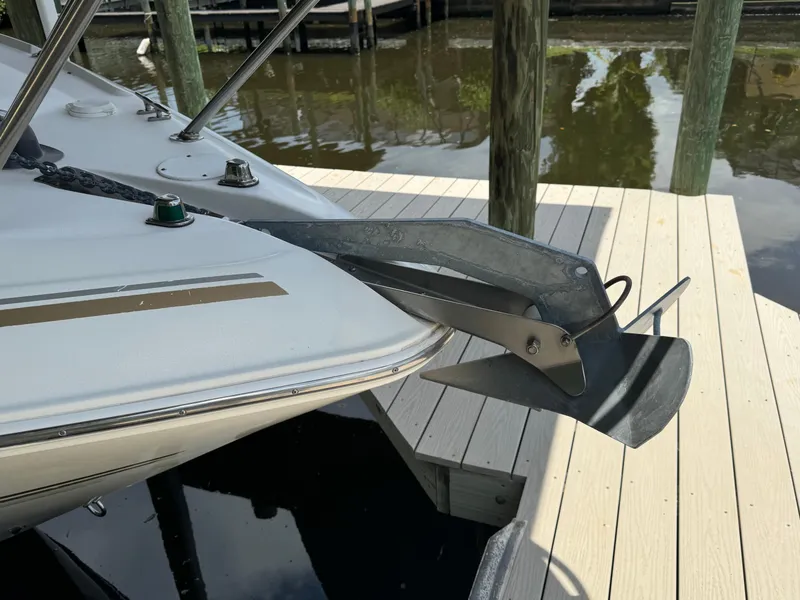 Slide: The Image of 2004 Larson 330 boat with anchor at dock. - 9