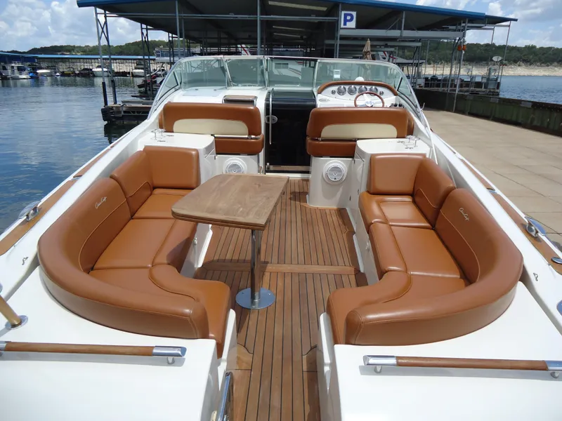 Slide: The Image of 2009 Chris-Craft Corsair 36 boat with luxurious tan leather seating and wooden deck. - 11