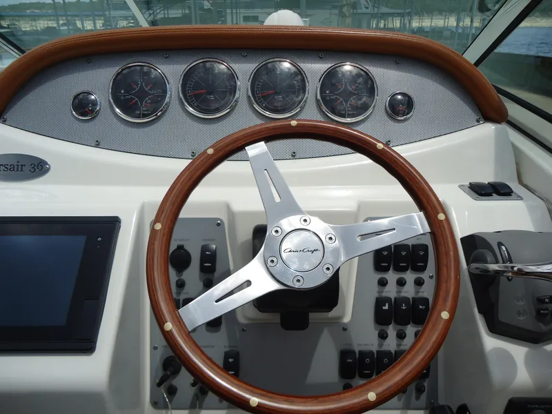 Slide: The Image of 2009 Chris-Craft Corsair 36 helm with wooden steering wheel and instrument panel. - 23