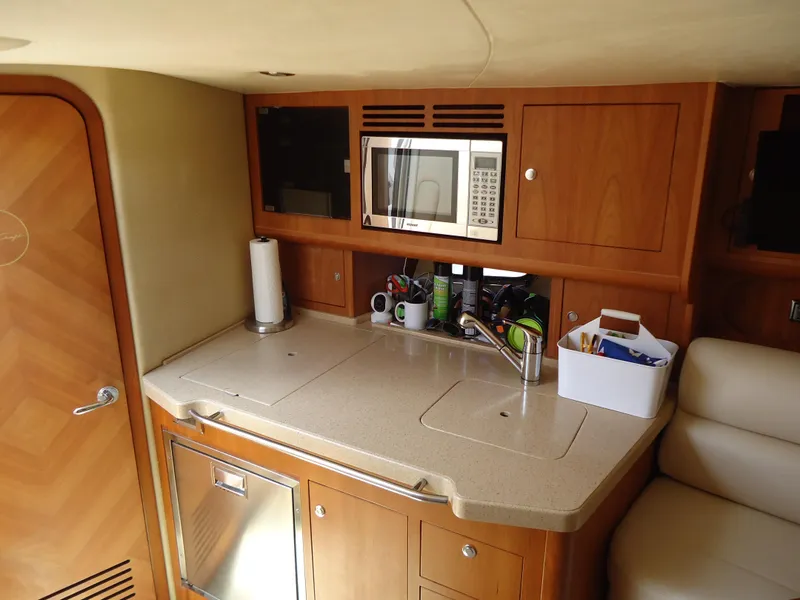 Slide: The Image of 2009 Chris-Craft Corsair 36 galley with microwave, sink, and storage cabinets. - 28