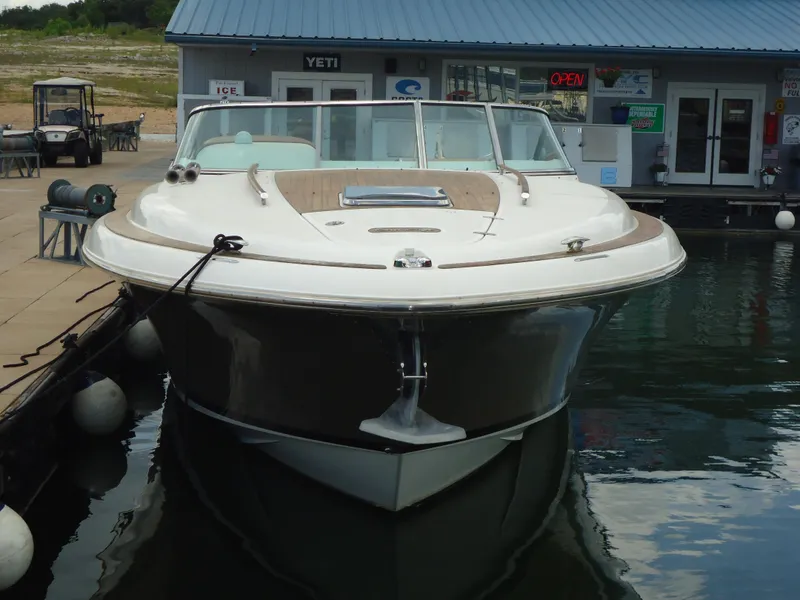 Slide: The Image of 2009 Chris-Craft Corsair 36 boat docked at marina, front view. - 32