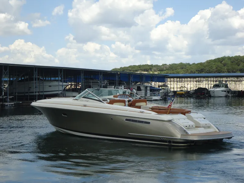 Slide: The Image of 2009 Chris-Craft Corsair 36 boat docked at a marina under a partly cloudy sky. - 6