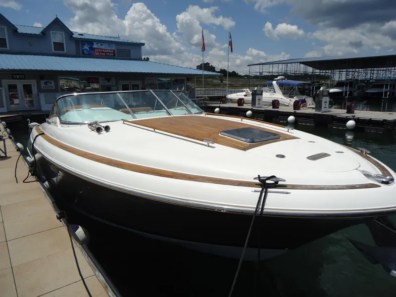Slide: The Image of 2009 Chris-Craft Corsair 36 docked at a marina under a partly cloudy sky. - 8