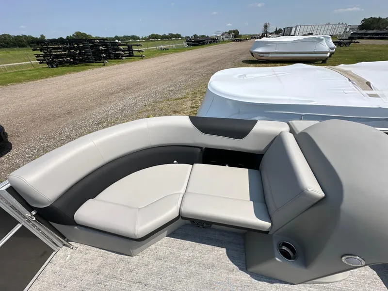 Slide: The Image of 2025 South Bay 220RSLE pontoon boat with gray seating and outdoor view. - 10