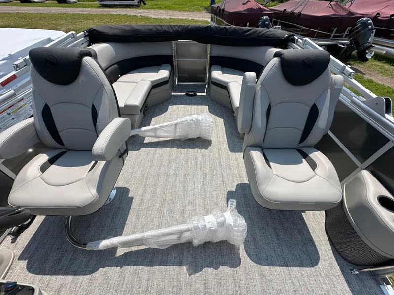 Slide: The Image of 2025 South Bay 220RSLE pontoon boat interior with plush seating and modern design. - 2