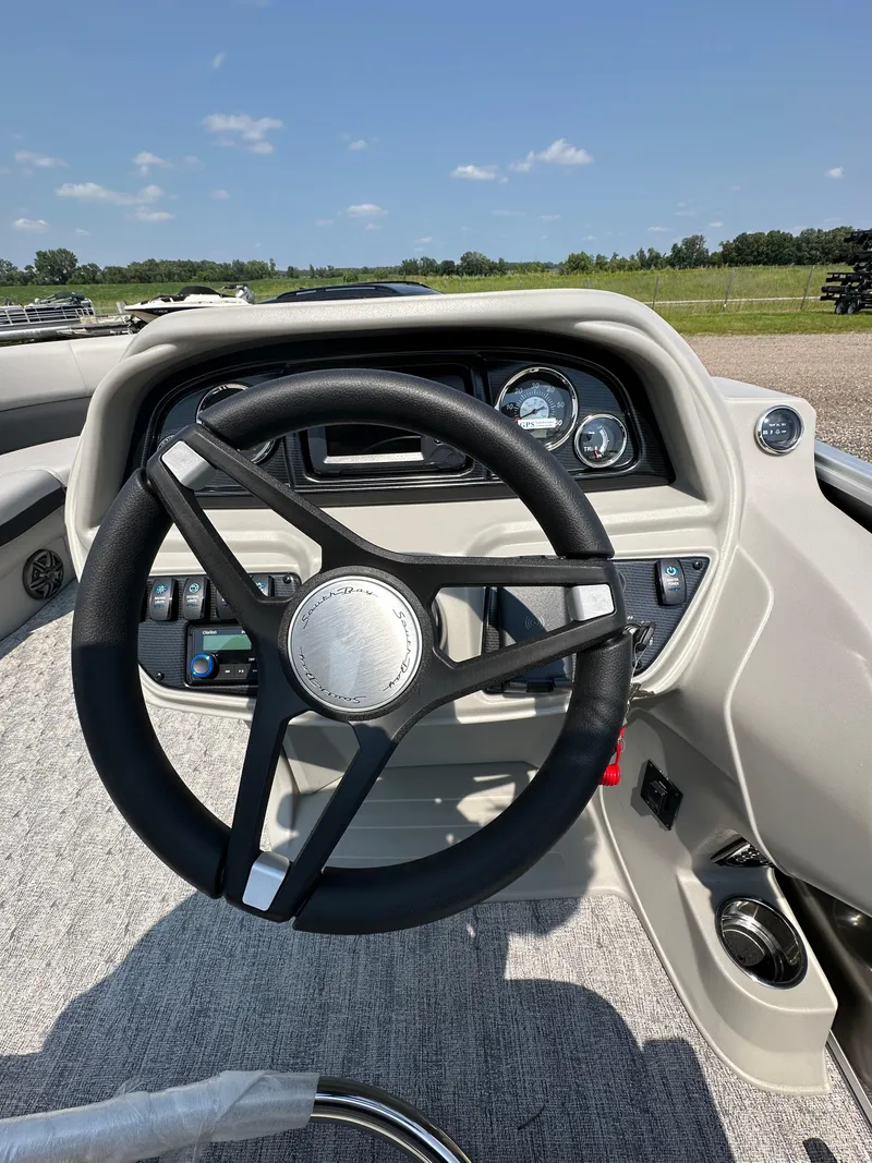 Slide: The Image of Steering console of 2025 South Bay 220RSLE pontoon boat under clear sky. - 4