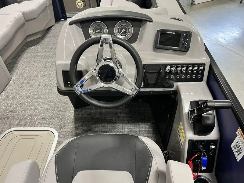 Slide: The Image of 2025 Barletta ARIA A22UC boat dashboard with steering wheel and control panel. - 2