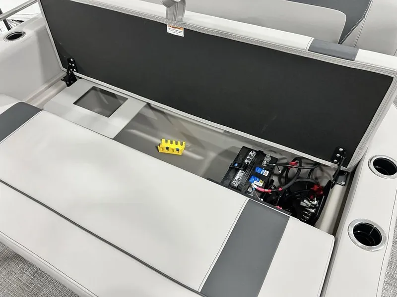 Slide: The Image of 2025 Barletta ARIA A22UC boat storage compartment with battery and wiring. - 22