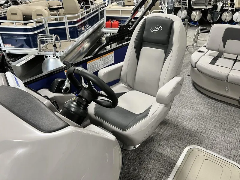 Slide: The Image of 2025 Barletta ARIA A22UC boat interior with captain's chair and steering wheel. - 3