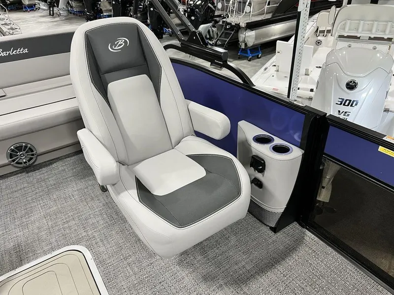 Slide: The Image of 2025 Barletta ARIA A22UC boat interior with captain's chair and cup holders. - 7