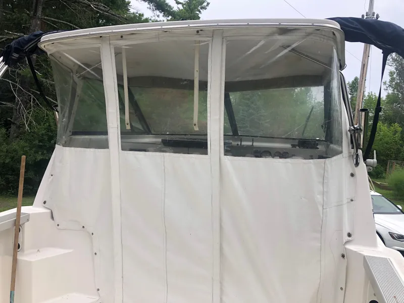 Slide: The Image of 1997 Bayliner Ciera 2452 Express boat with covered cockpit and clear windows. - 12