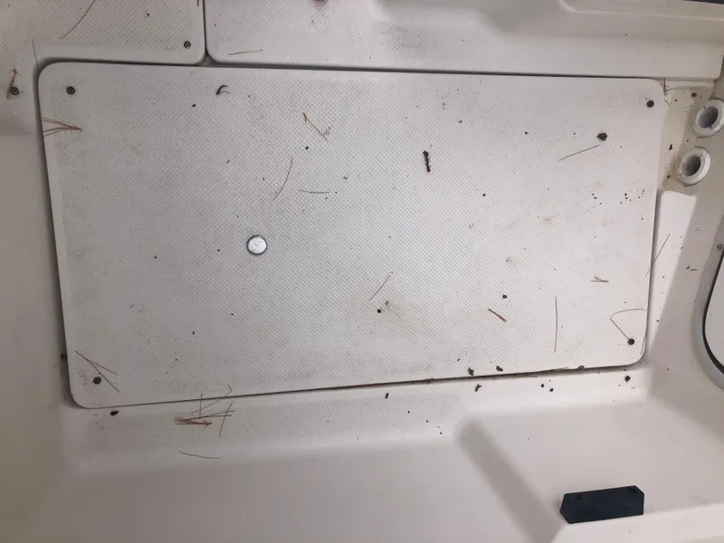 Slide: The Image of 1997 Bayliner Ciera 2452 Express deck with scattered debris and dirt. - 26