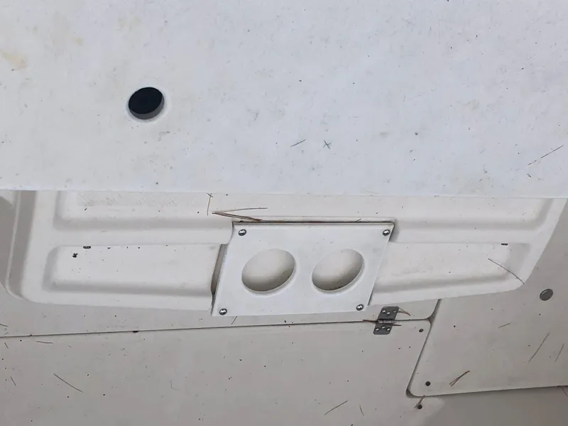 Slide: The Image of 1997 Bayliner Ciera 2452 Express boat detail showing cup holders and deck surface. - 33