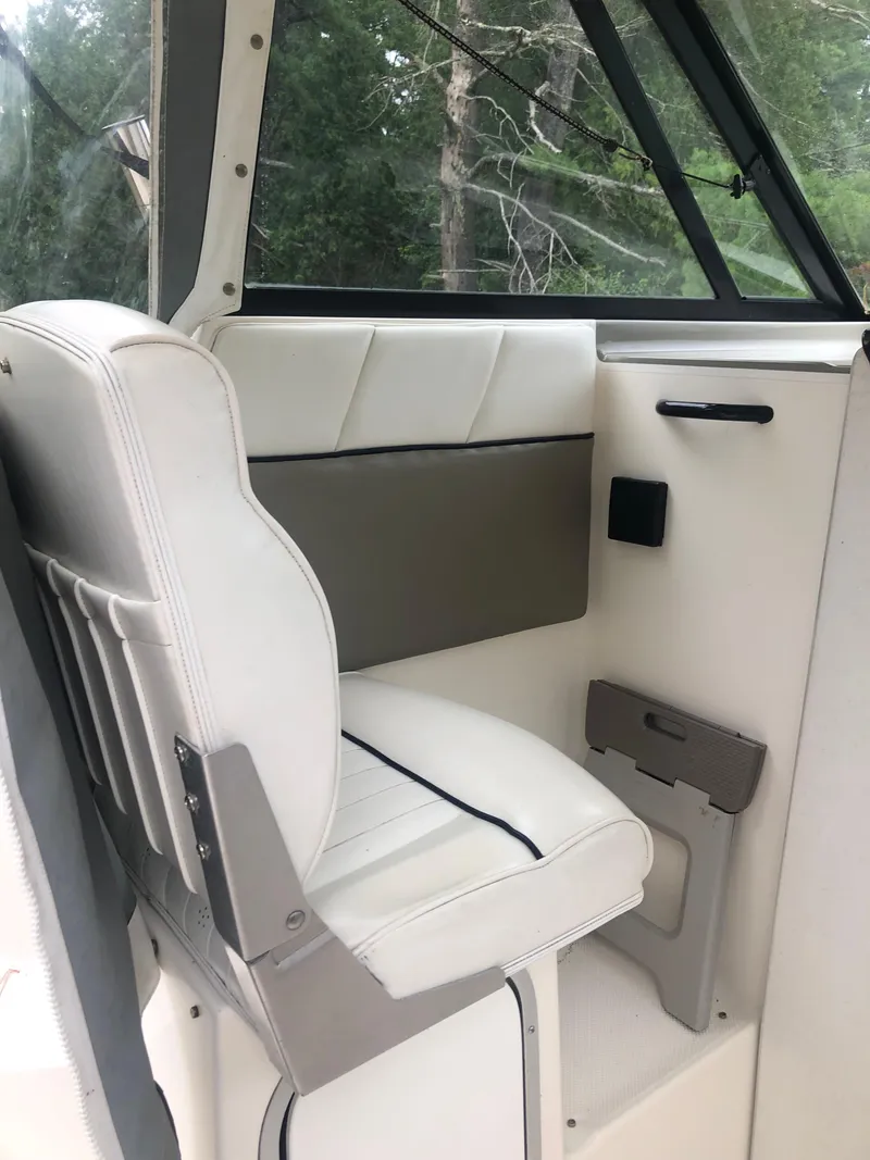 Slide: The Image of 1997 Bayliner Ciera 2452 Express interior with white seating and window view. - 41