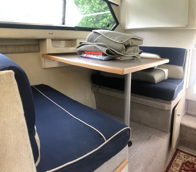 Slide: The Image of 1997 Bayliner Ciera 2452 Express cabin interior with blue seating and table. - 48