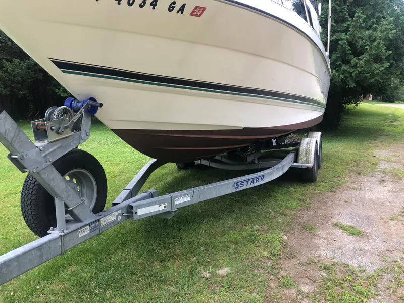 Slide: The Image of 1997 Bayliner Ciera 2452 Express on trailer, parked on grass. - 6
