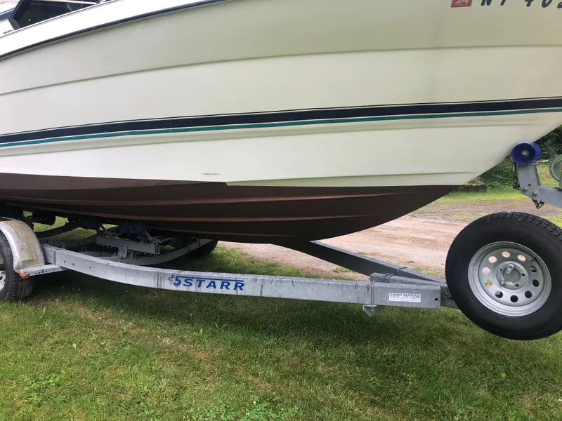 Slide: The Image of 1997 Bayliner Ciera 2452 Express on trailer, side view, parked on grass. - 2