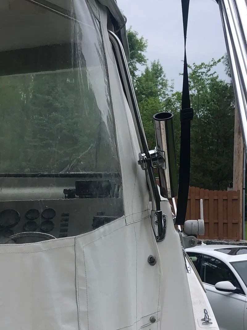 Slide: The Image of 1997 Bayliner Ciera 2452 Express boat with cockpit view and canopy. - 32