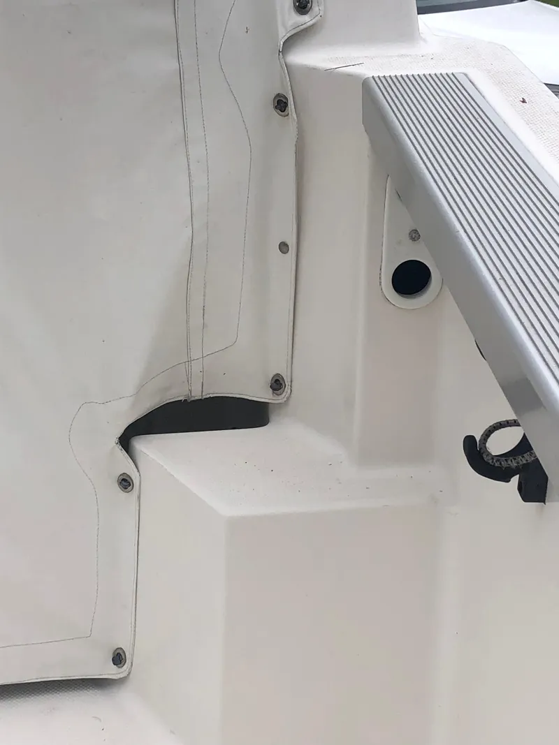 Slide: The Image of 1997 Bayliner Ciera 2452 Express boat interior detail with white upholstery and step. - 36