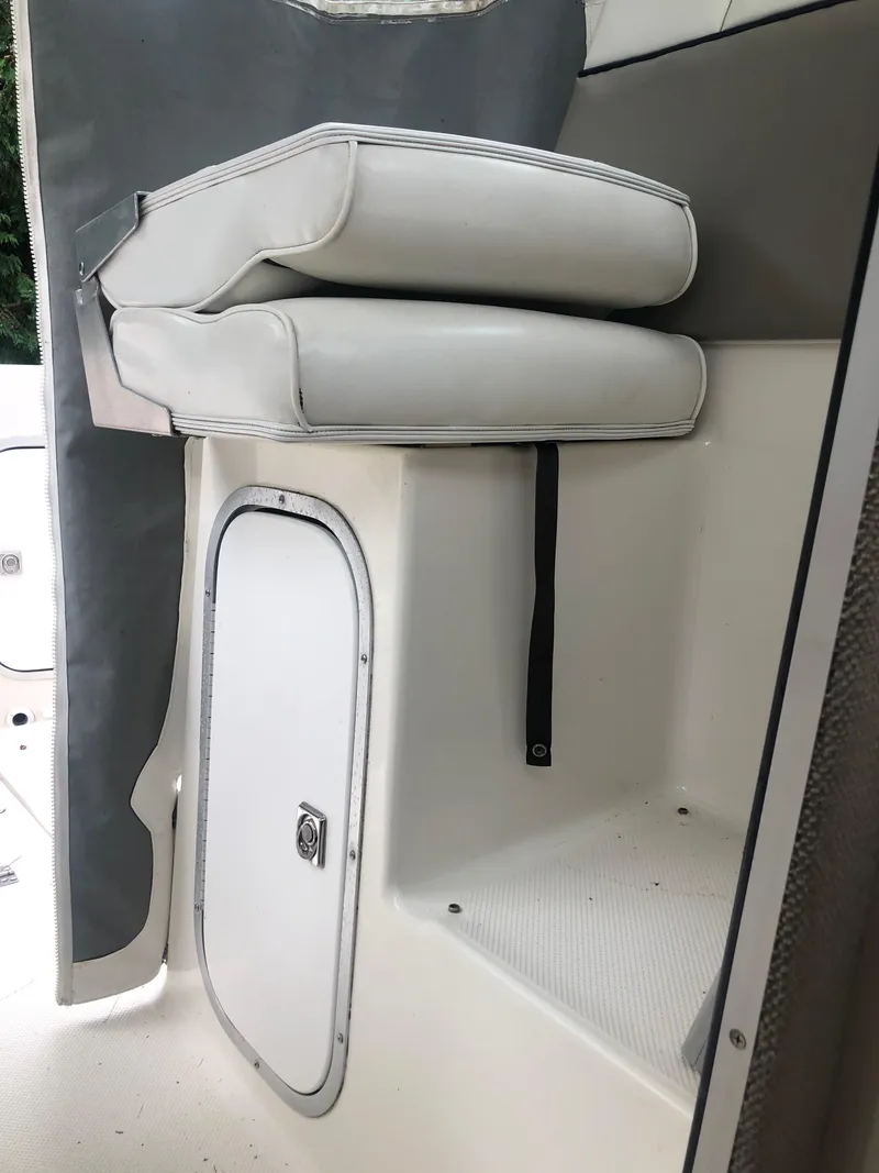 Slide: The Image of 1997 Bayliner Ciera 2452 Express interior seating and storage compartment. - 42