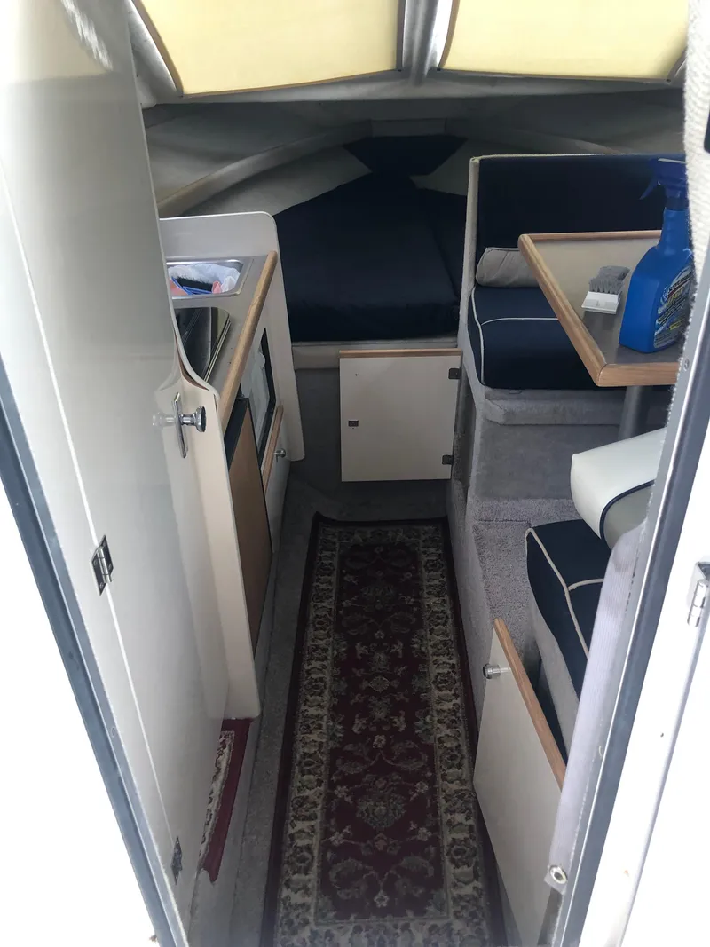 Slide: The Image of 1997 Bayliner Ciera 2452 Express cabin interior with seating, table, and kitchenette. - 43