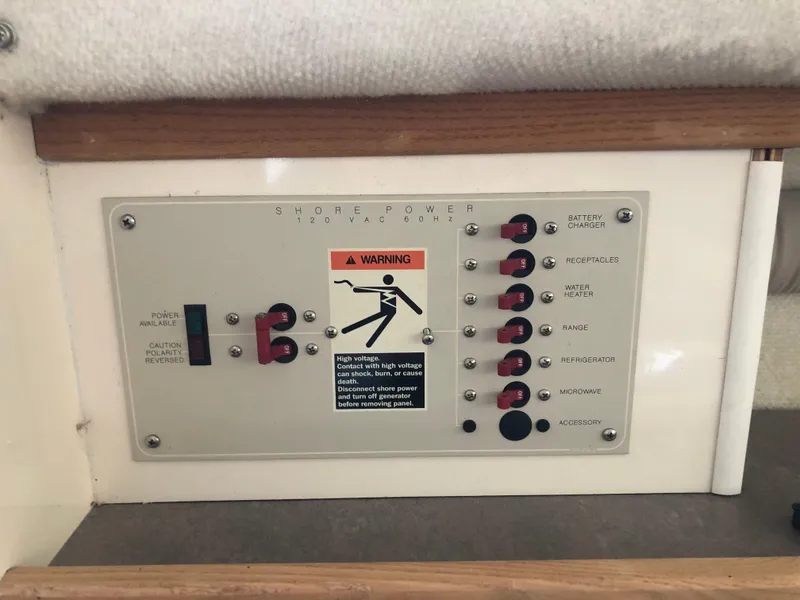 Slide: The Image of Electrical panel of 1997 Bayliner Ciera 2452 Express boat with warning label and switches. - 45