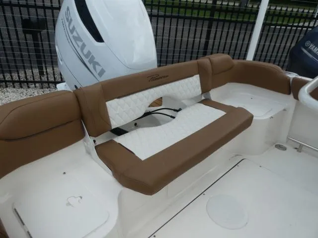 Slide: The Image of Pioneer Islander 222 (2025) boat interior with brown seating and storage compartment. - 10