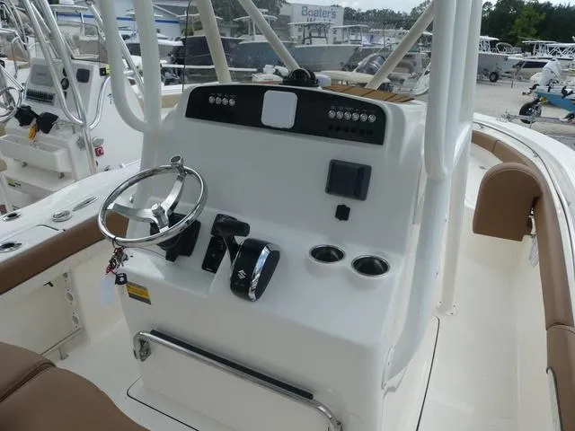 Slide: The Image of 2025 Pioneer Islander 222 boat console with steering wheel and controls. - 13