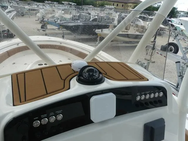 Slide: The Image of 2025 Pioneer Islander 222 boat interior with tan seating and white deck. - 17