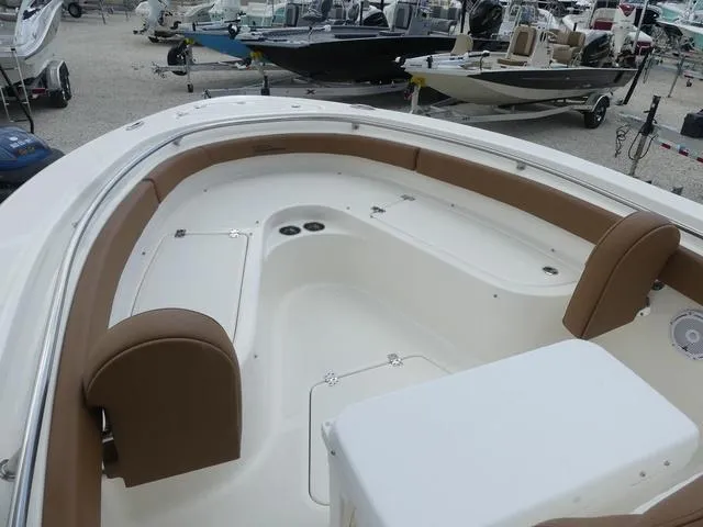 Slide: The Image of Bow seating area of 2025 Pioneer Islander 222 boat with tan cushions. - 18