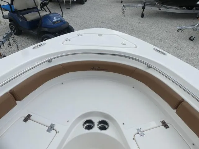 Slide: The Image of 2025 Pioneer Islander 222 boat interior with tan and white seating. - 19