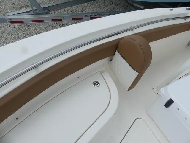 Slide: The Image of Interior of 2025 Pioneer Islander 222 boat with white and brown seating. - 20