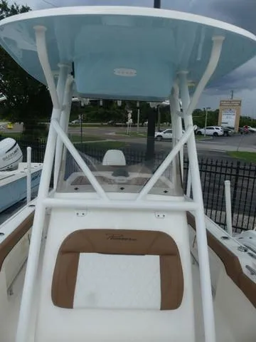 Slide: The Image of 2025 Pioneer Islander 222 boat interior with tan seating and white deck. - 23