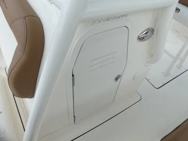 Slide: The Image of Storage compartment of 2025 Pioneer Islander 222 boat with brown cushions. - 26