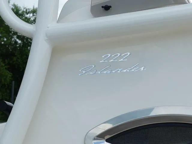 Slide: The Image of 2025 Pioneer Islander 222 boat side view with logo and American flag. - 6